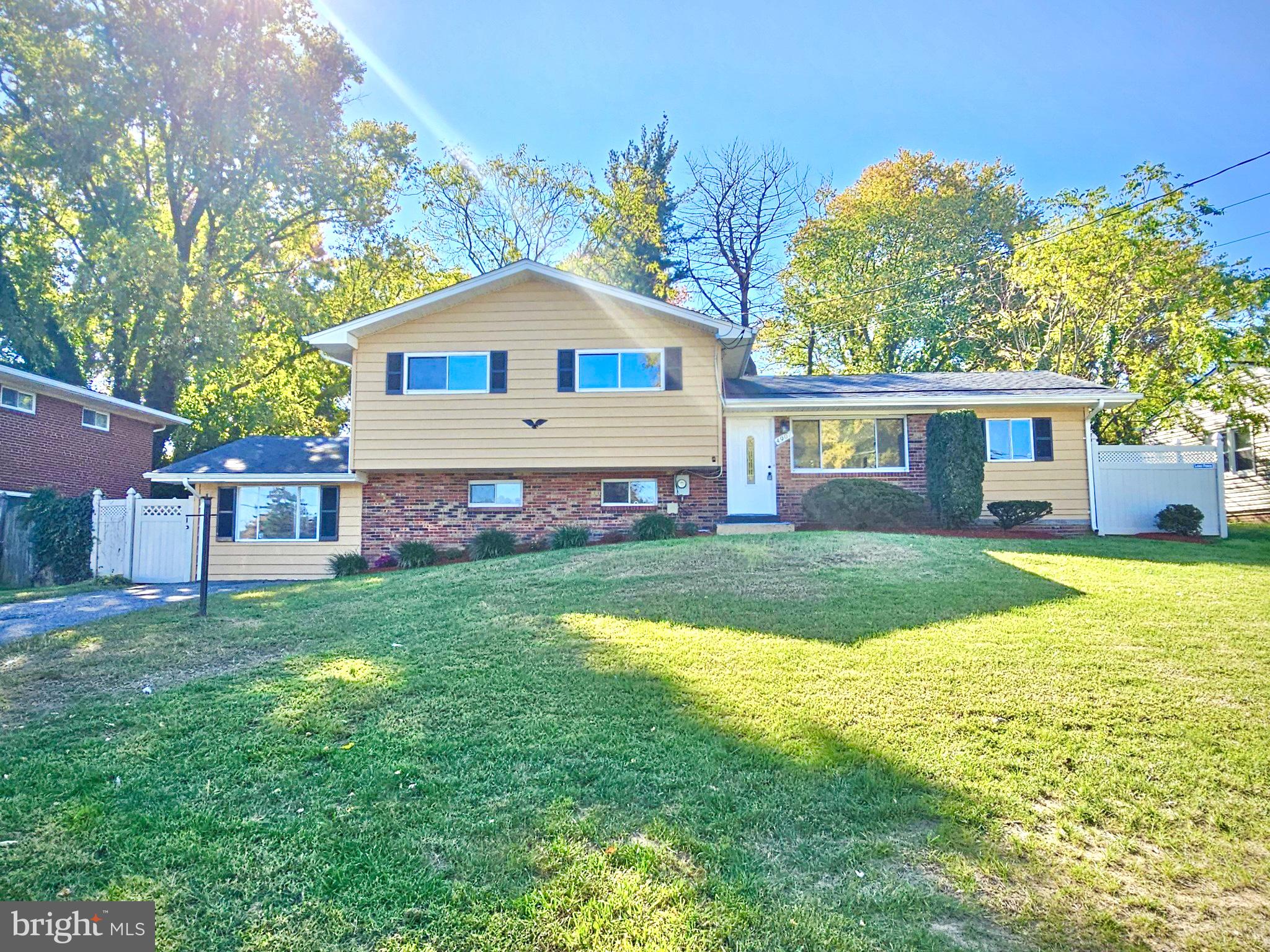 a front view of a house with yard and green space