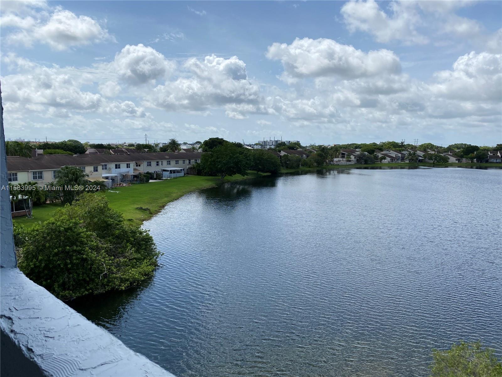 a view of a lake with houses in back