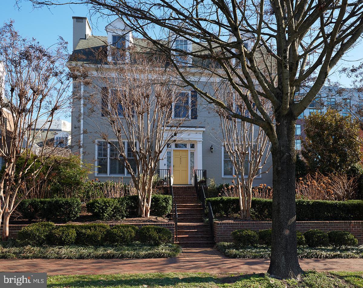 front view of a house with plants and trees