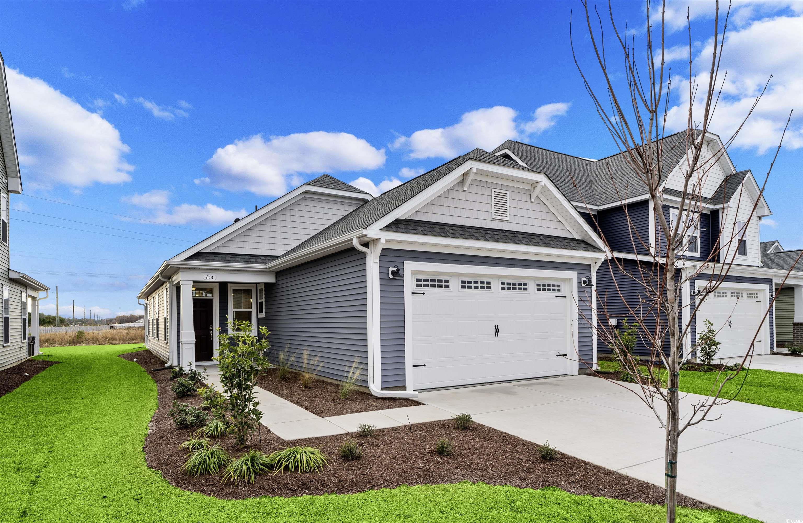 View of front facade featuring a garage and a fron