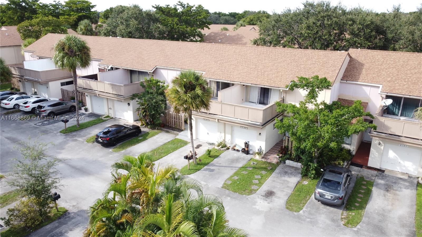 an aerial view of a house with garden space and street view