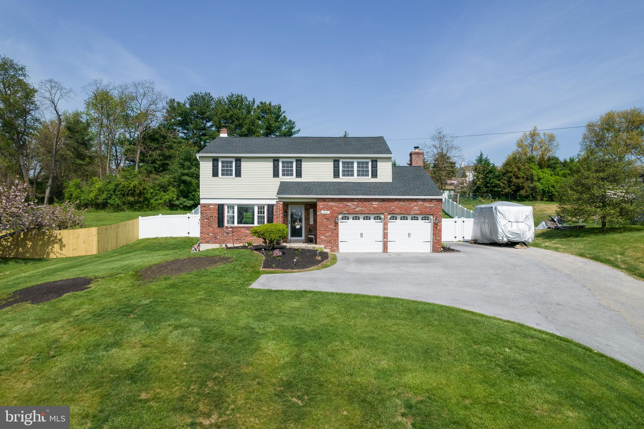 a front view of a house with a yard and a bike