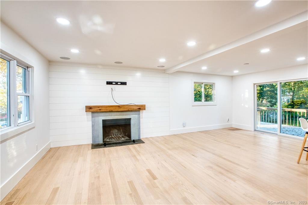 a view of empty room with wooden floor and fireplace