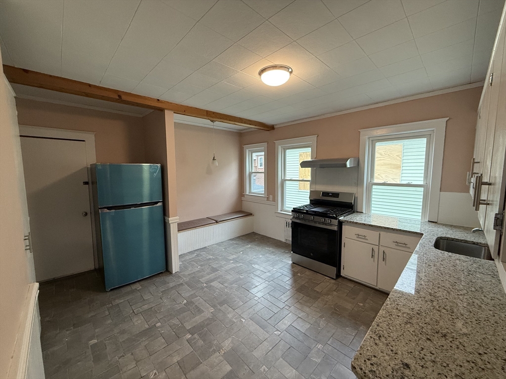 a kitchen with a refrigerator and a sink