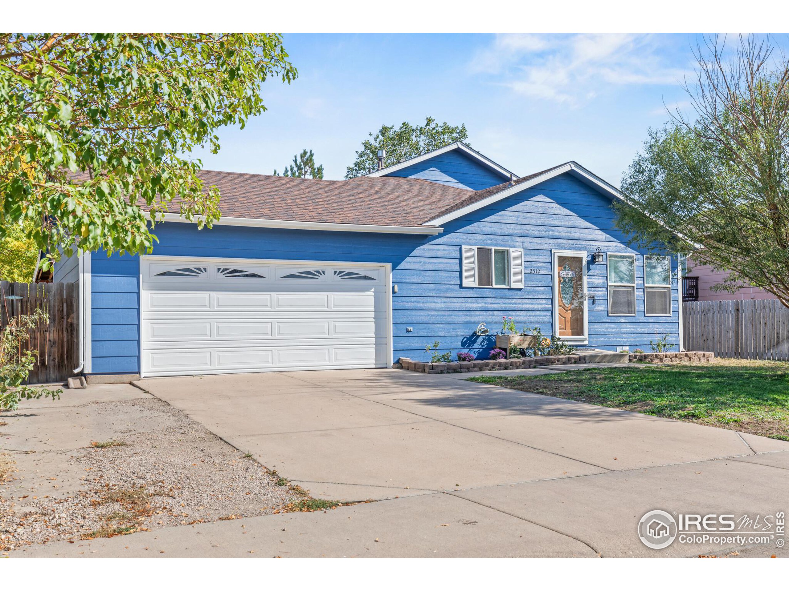 a view of a house with a yard and garage