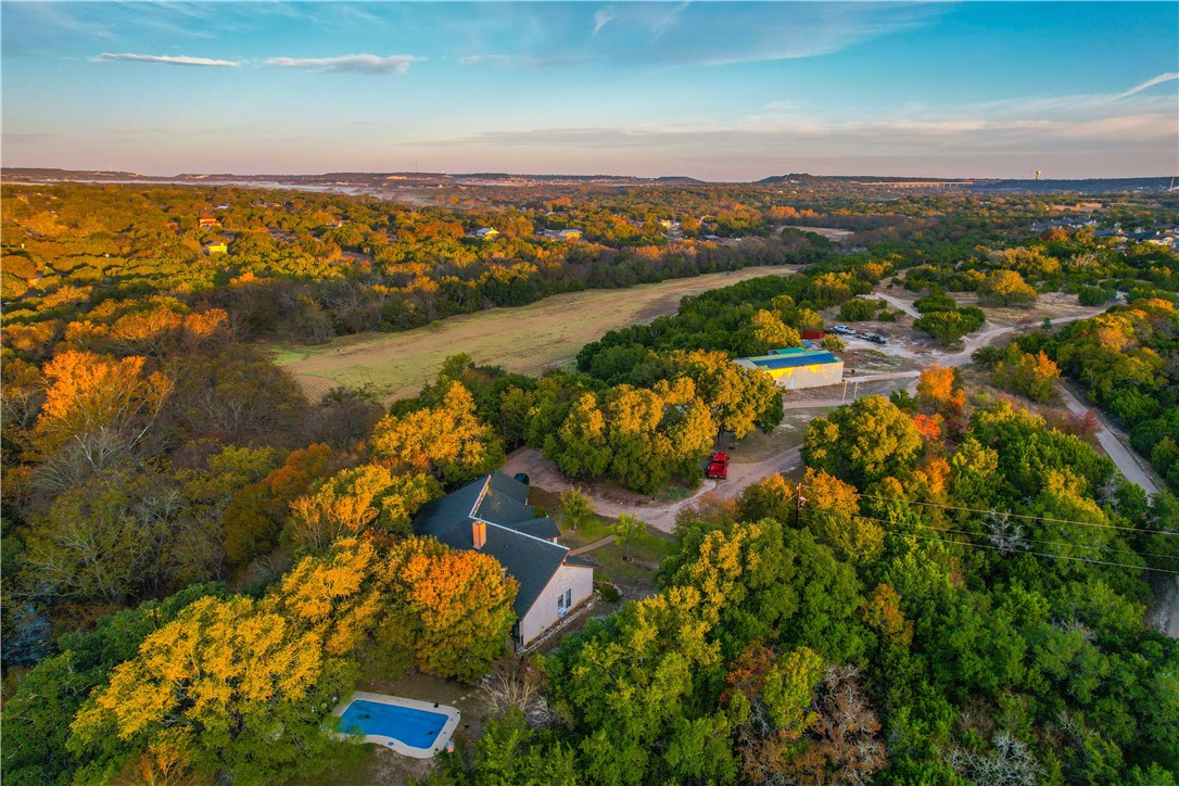 an aerial view of lake and residential houses with outdoor space