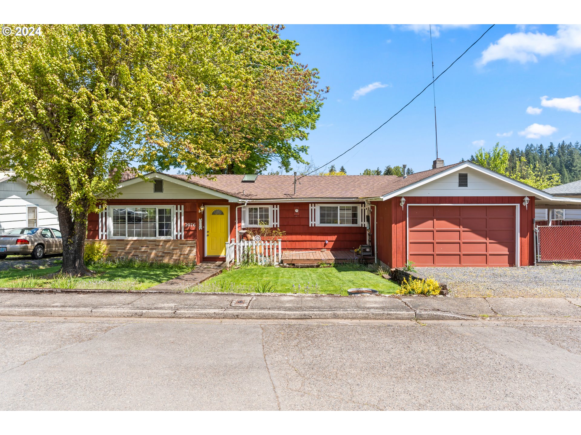 a front view of a house with a yard and a garage