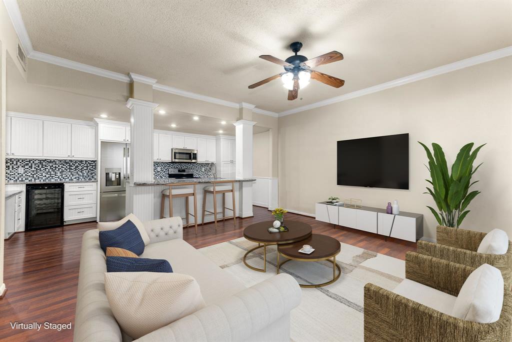 a living room with furniture potted plant and a flat screen tv