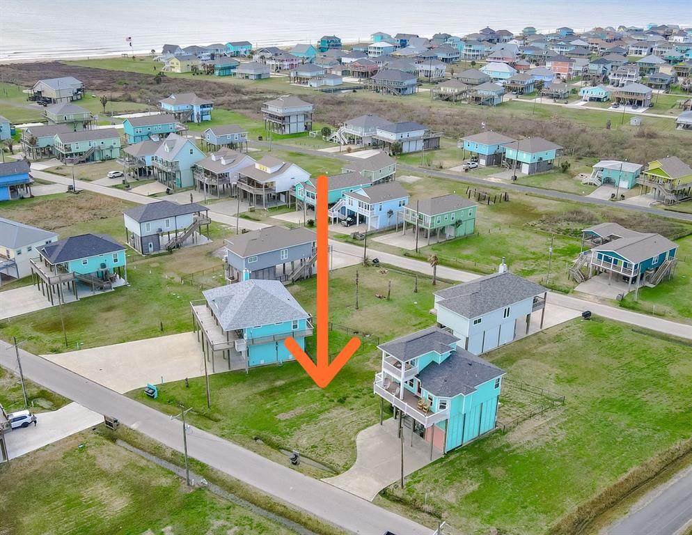 an aerial view of residential houses with outdoor space and river