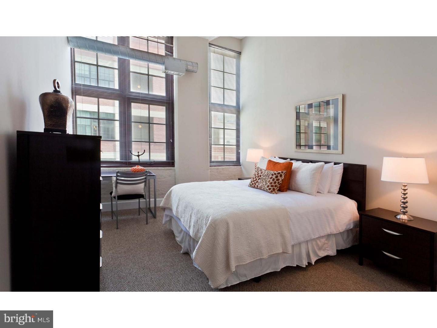 a living room with a bed furniture and a window