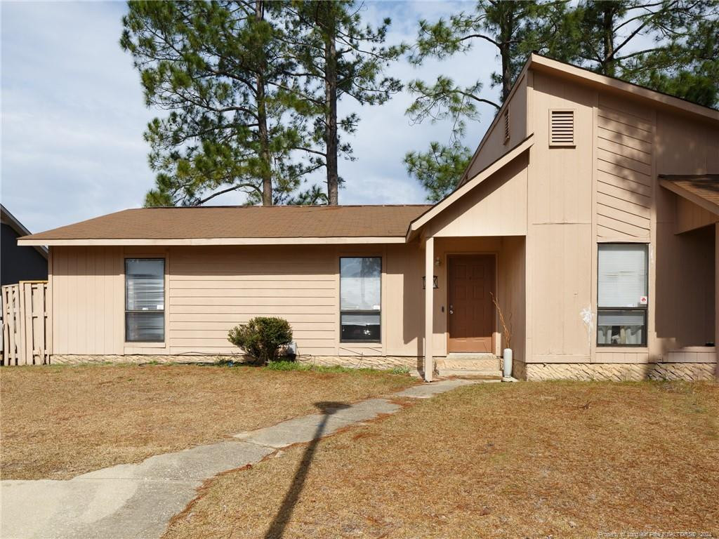 a view of a house with a yard and garage