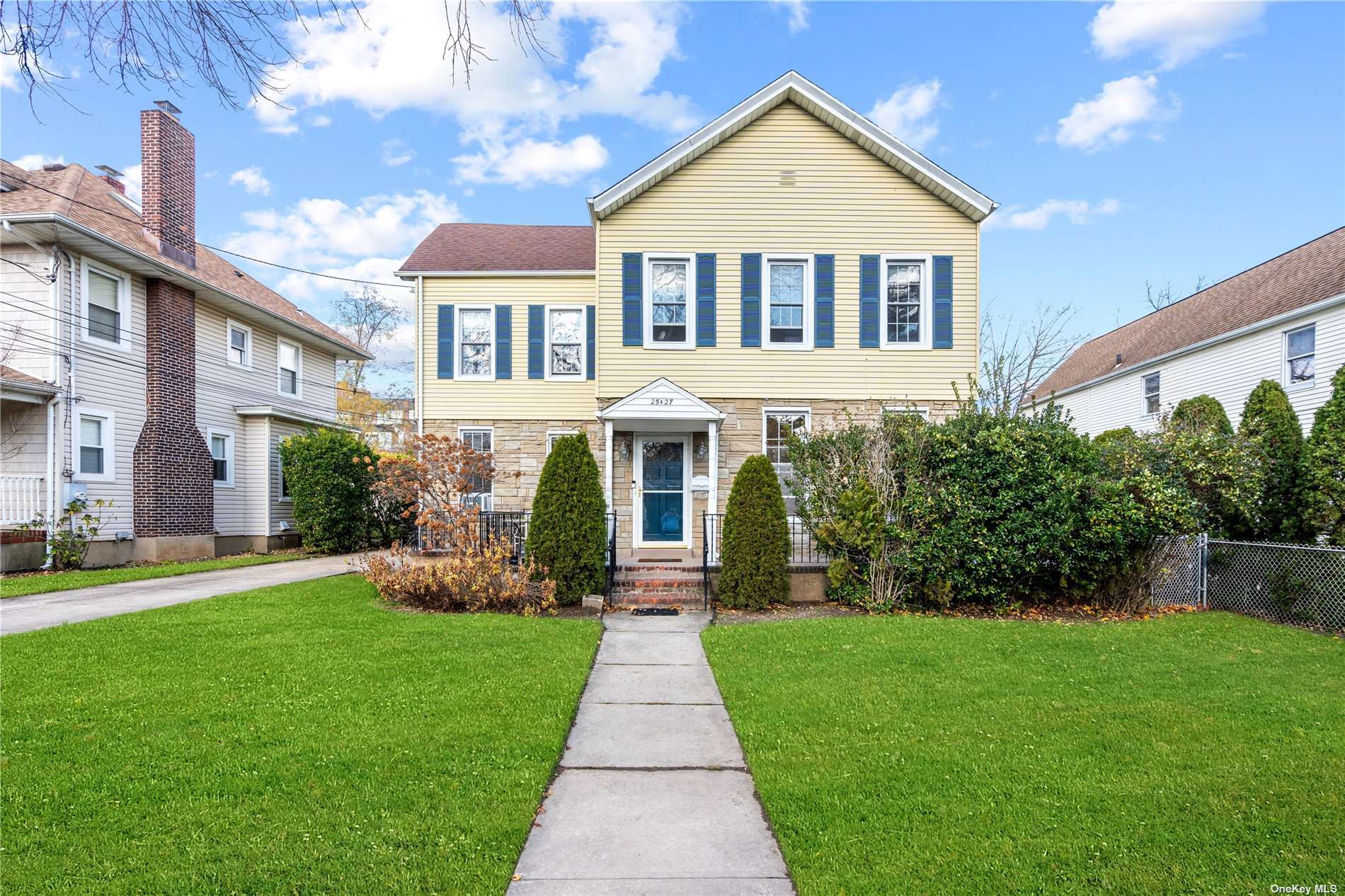 a front view of a house with a yard