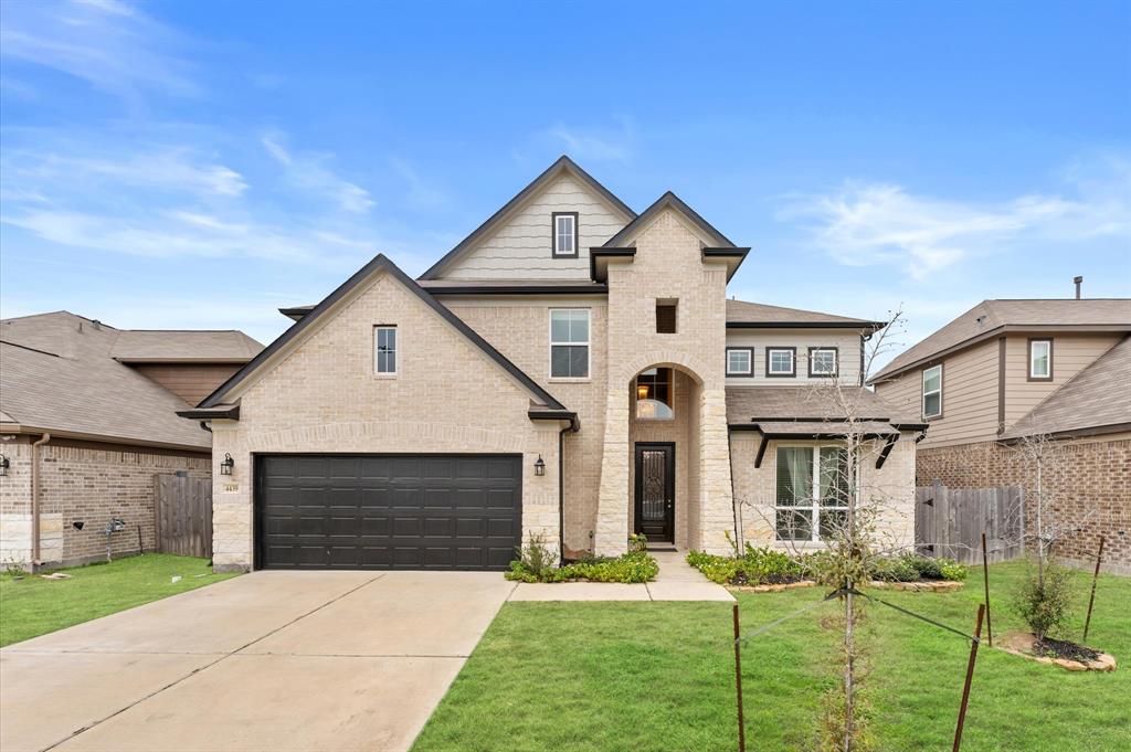 a front view of a house with a yard and garage