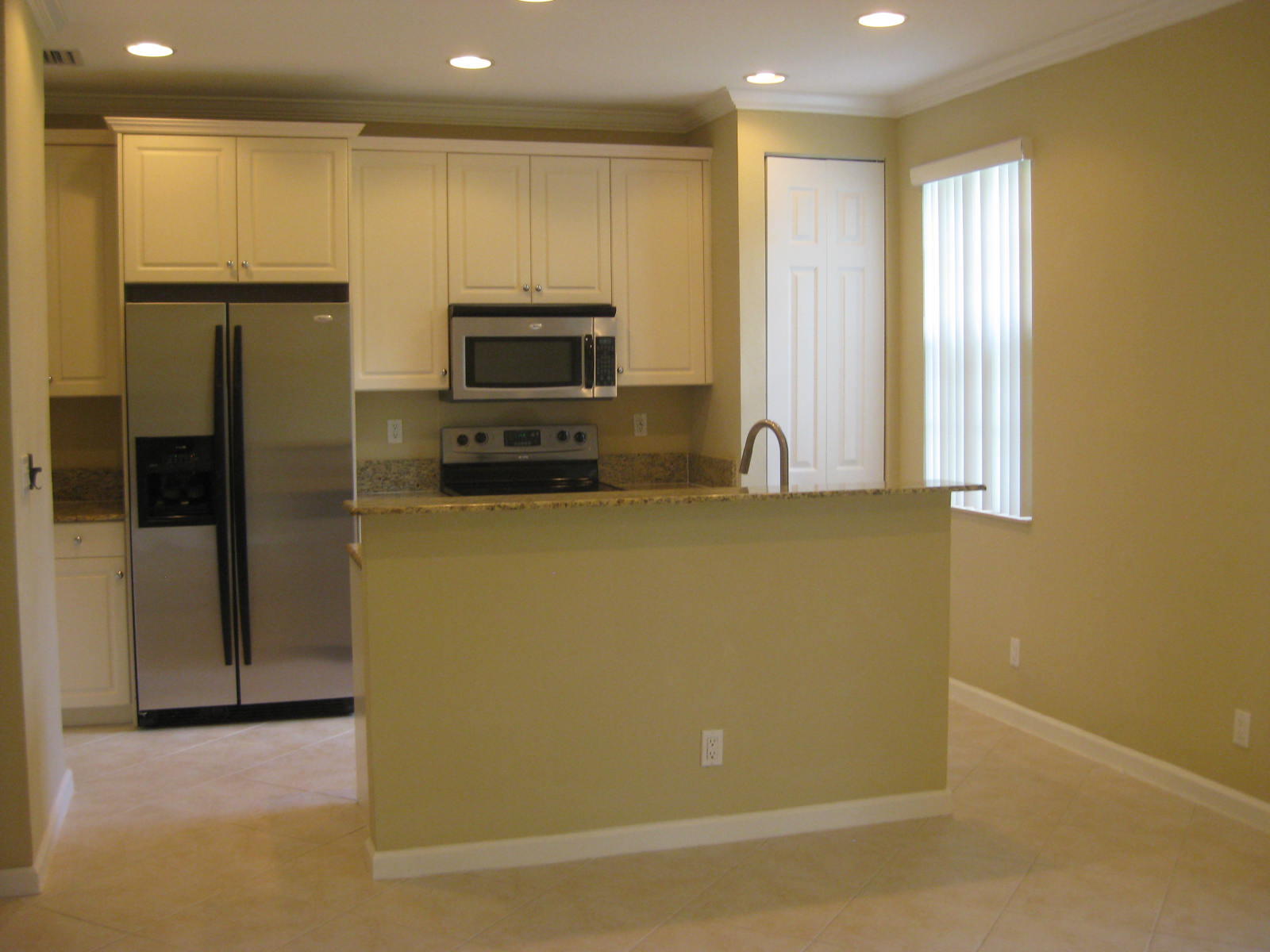 a kitchen with stainless steel appliances a refrigerator a stove a microwave and cabinets