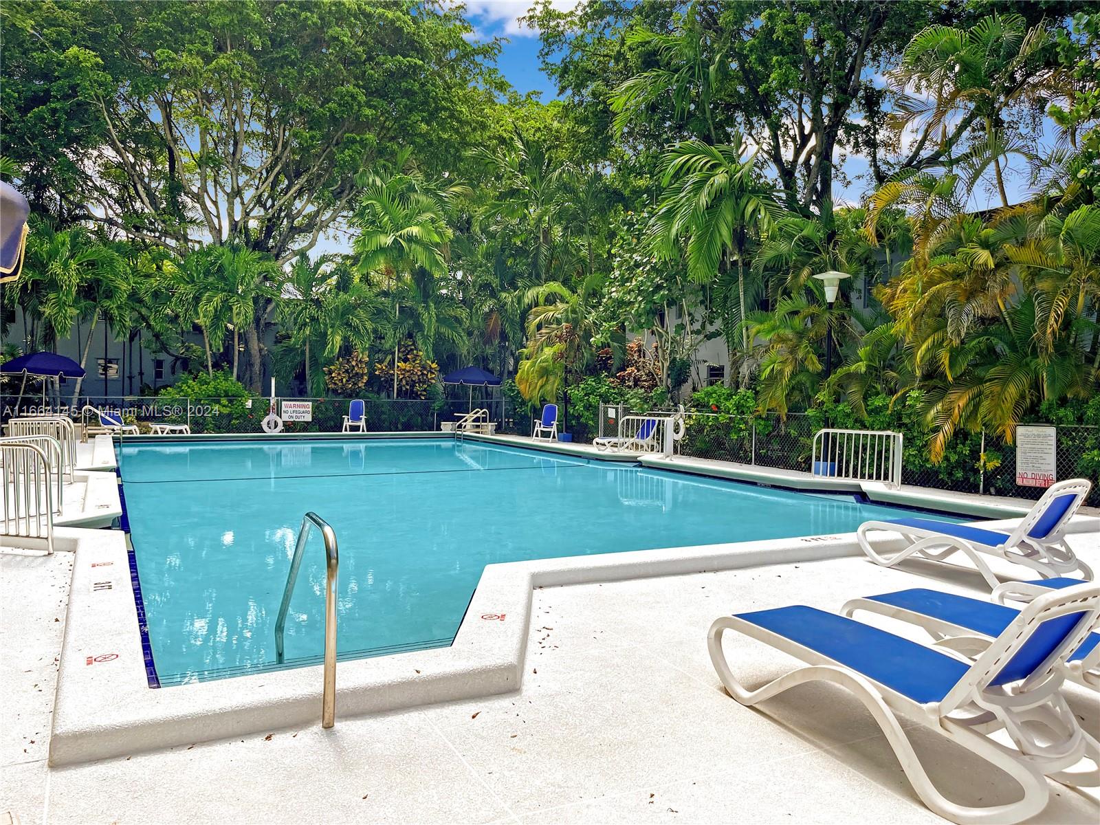 a view of a pool with a yard