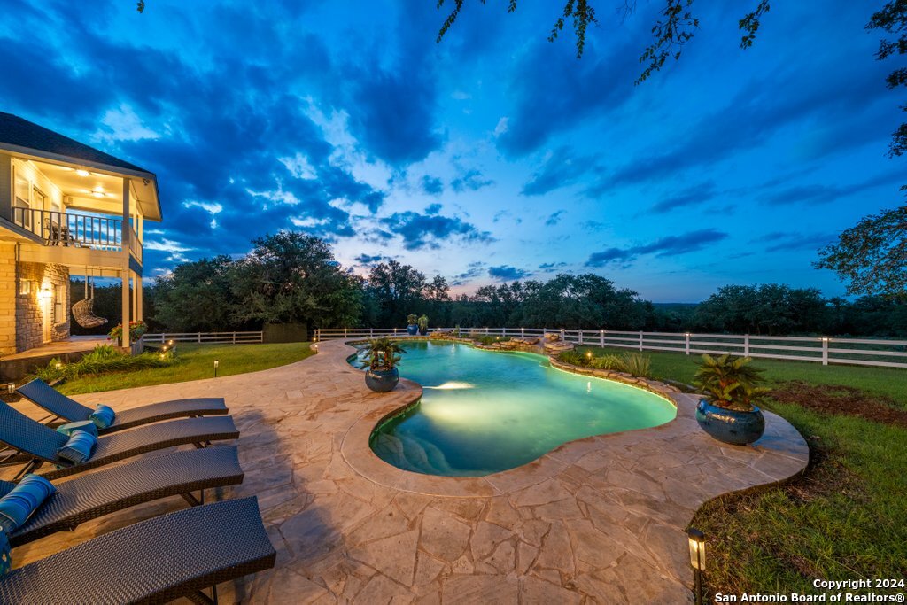 a view of a swimming pool with lounge chairs