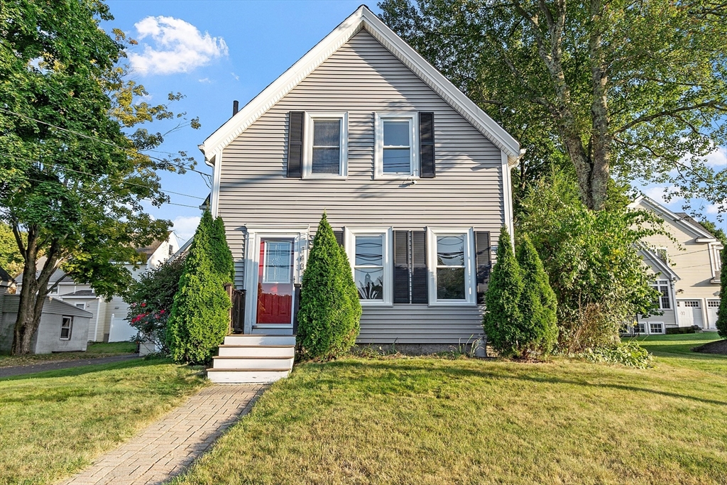 a front view of a house with garden