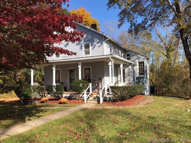 a front view of house with yard patio and outdoor seating