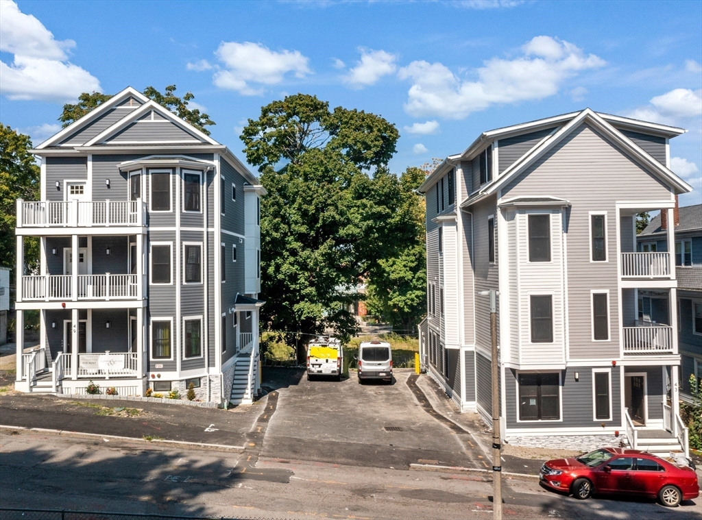 a front view of a residential apartment building with a yard