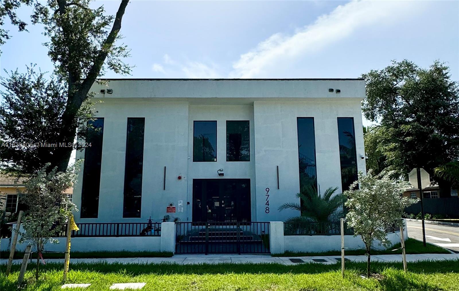 a view of house with yard and outdoor seating