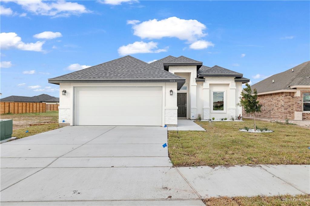 a view of a house with a yard and garage