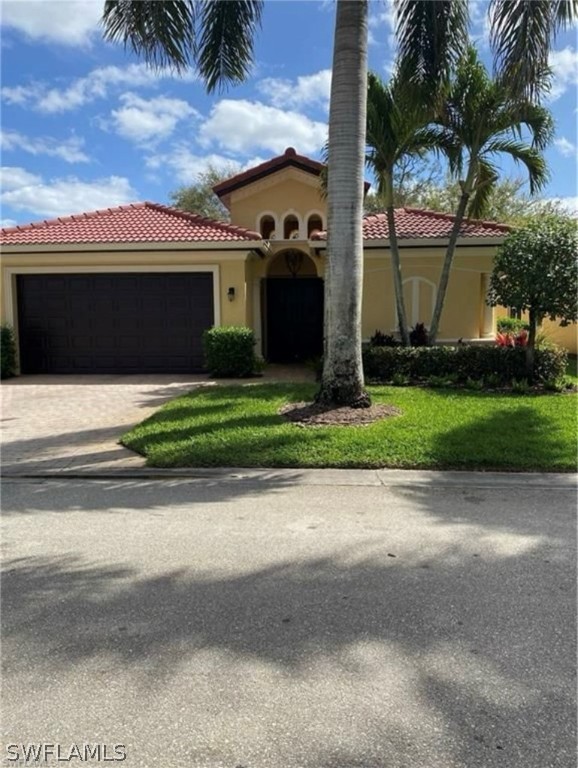 a front view of a house with a garden and yard