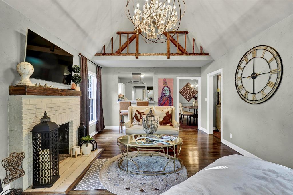 a living room with furniture a flat screen tv and a wall clock