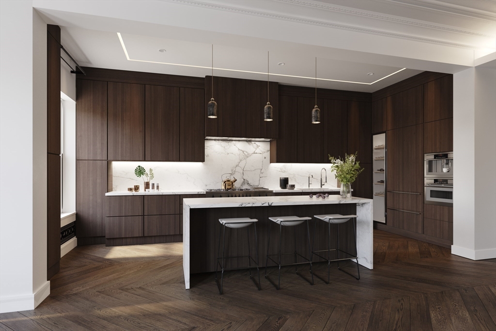 a kitchen with granite countertop a sink cabinets and wooden floor