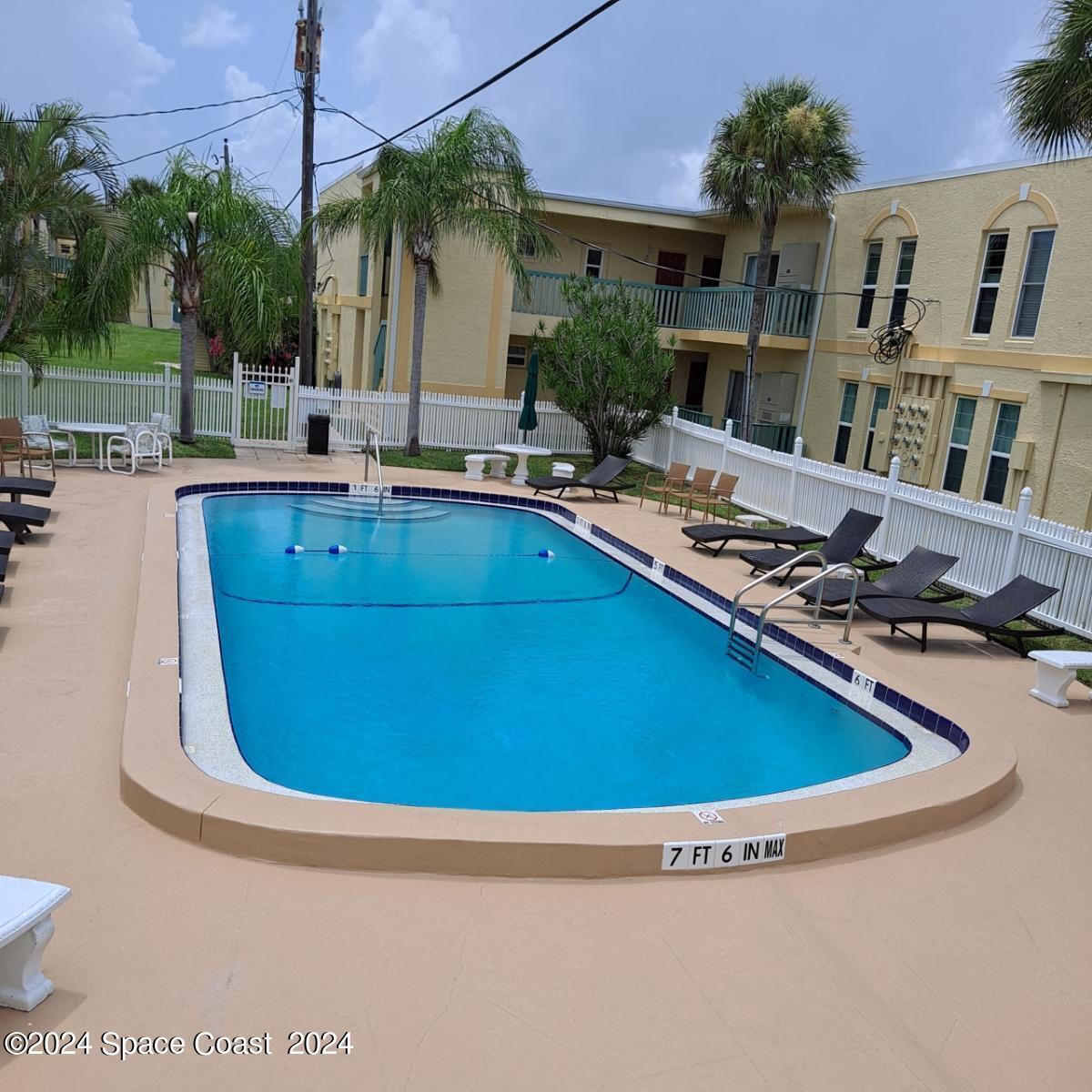 a swimming pool with outdoor seating and yard