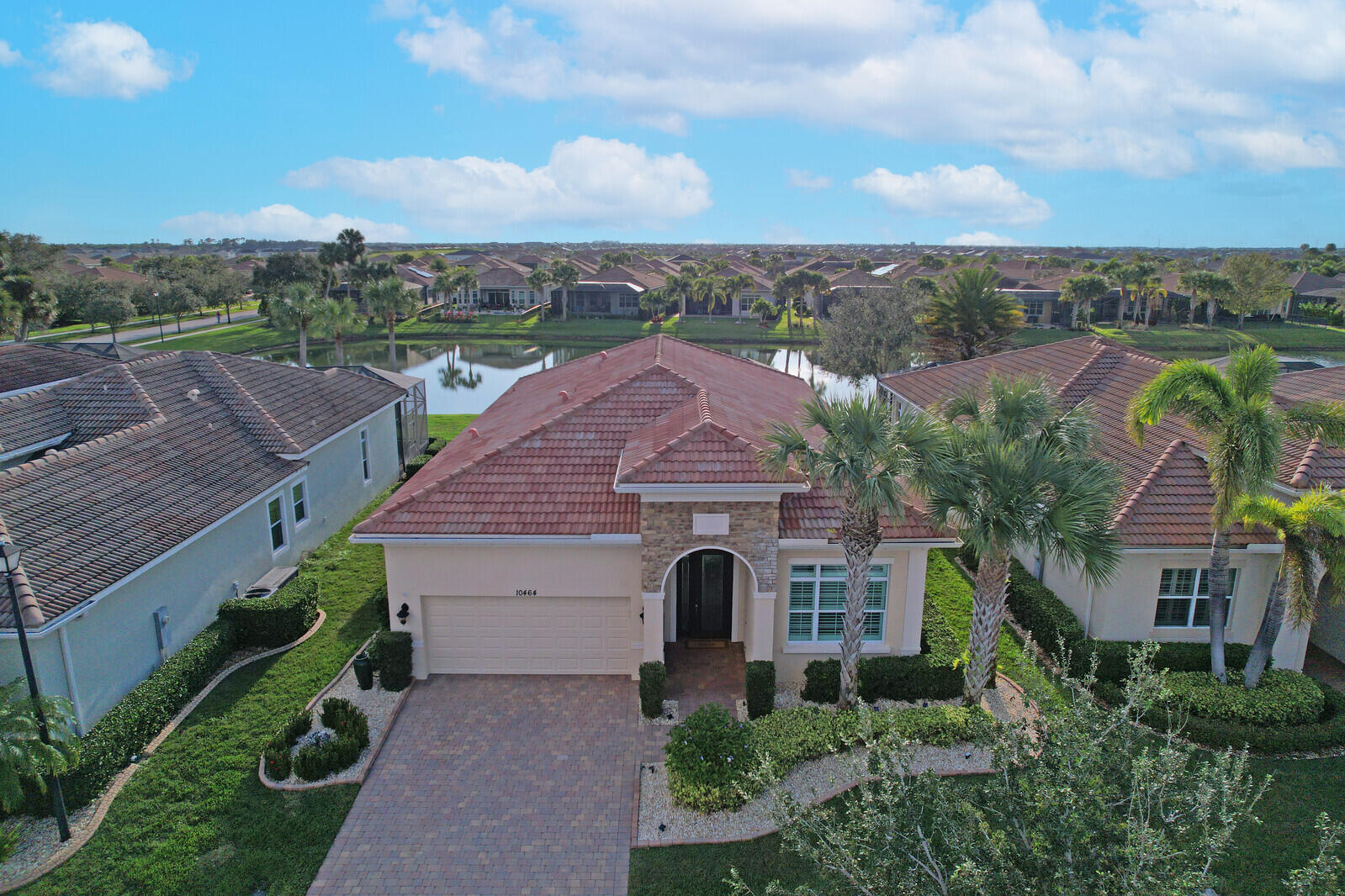 an aerial view of multiple houses with a yard