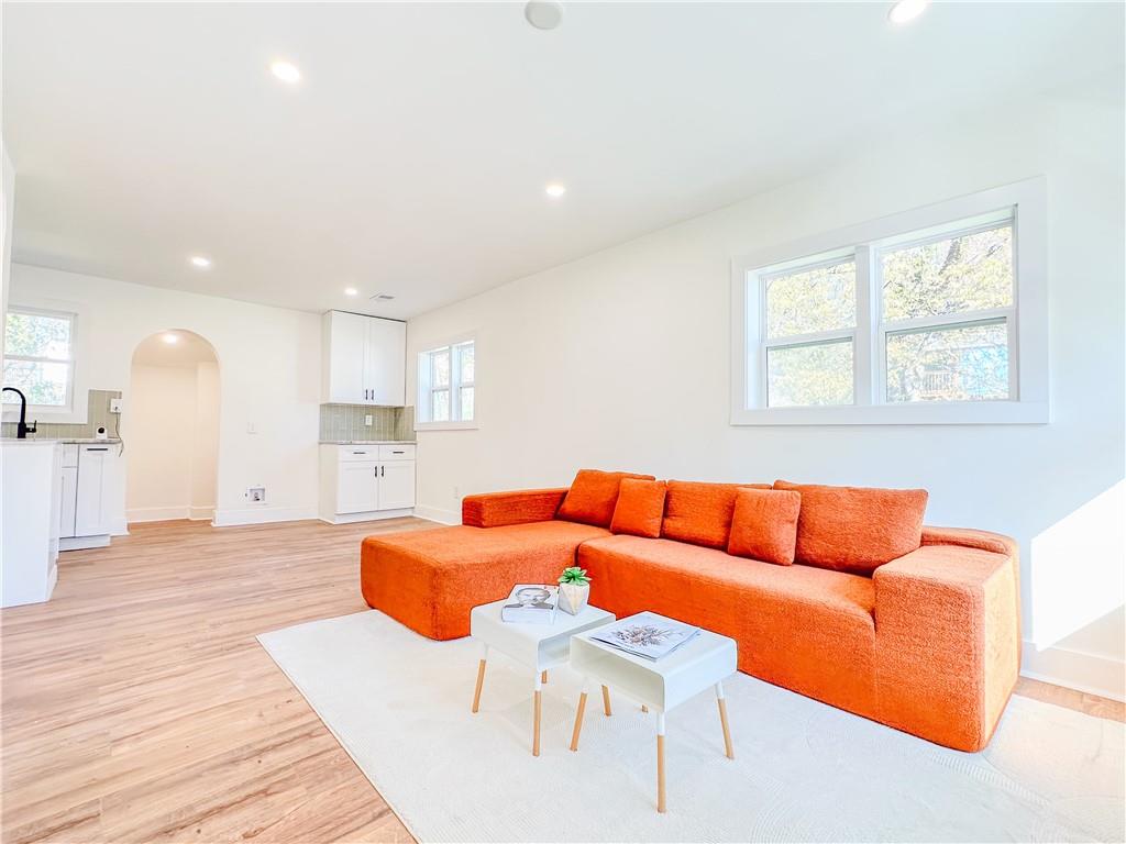 a living room with furniture and kitchen view