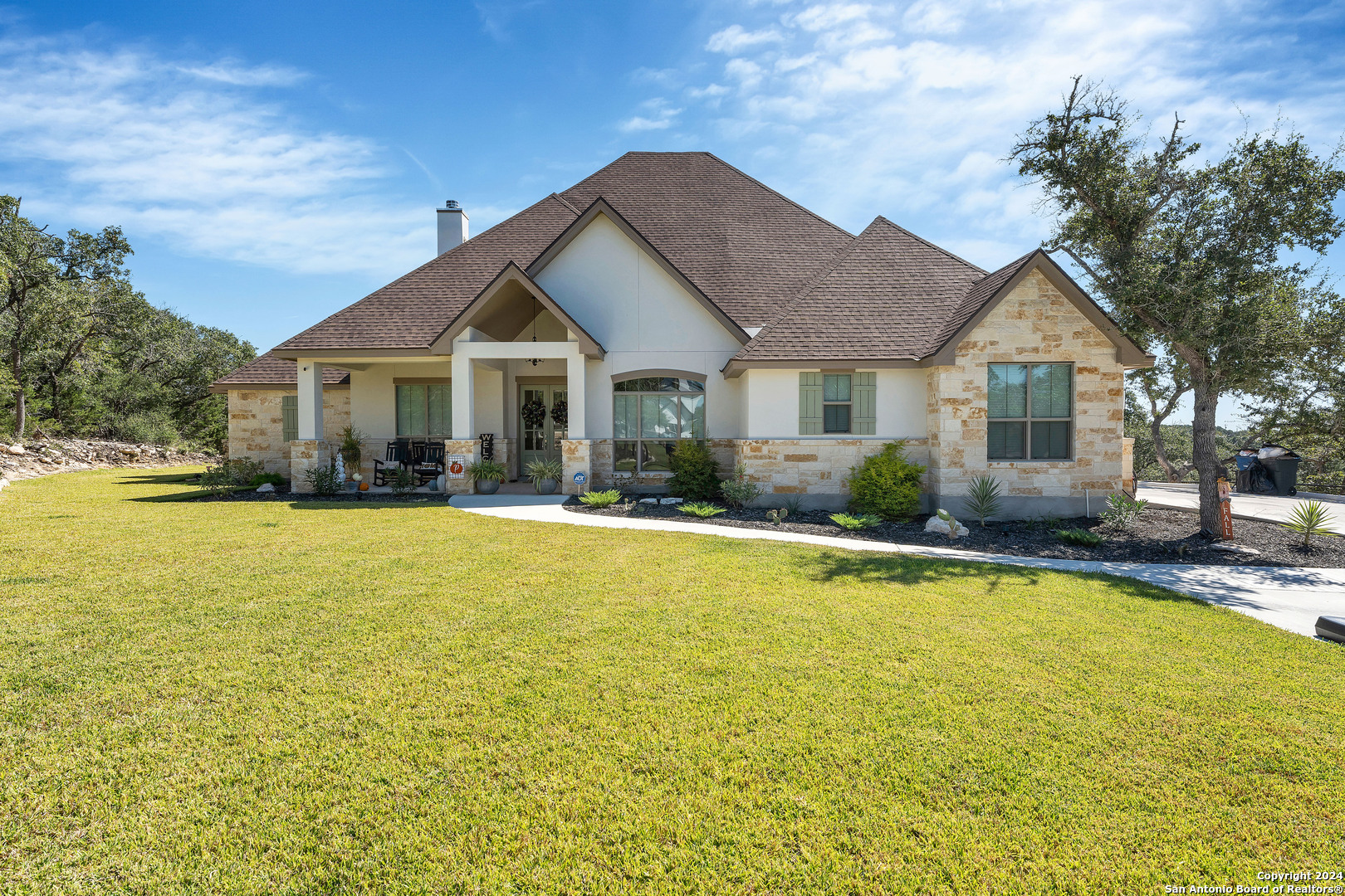 a front view of house with swimming pool and porch