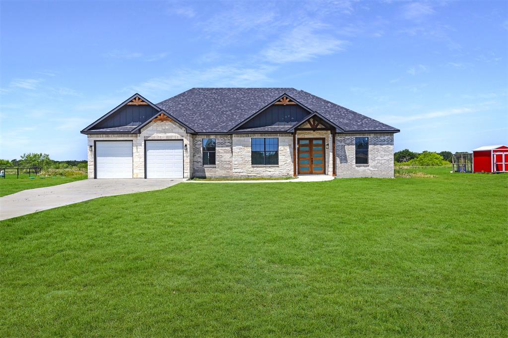 a front view of house with yard and green space