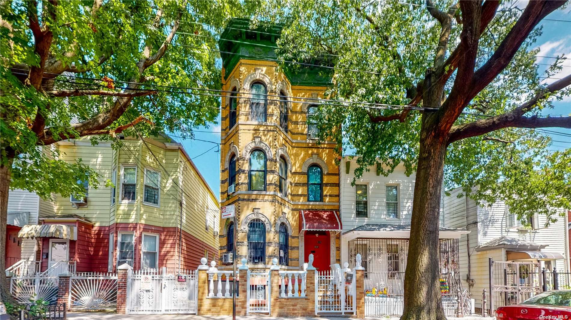 a front view of a residential apartment building with a yard