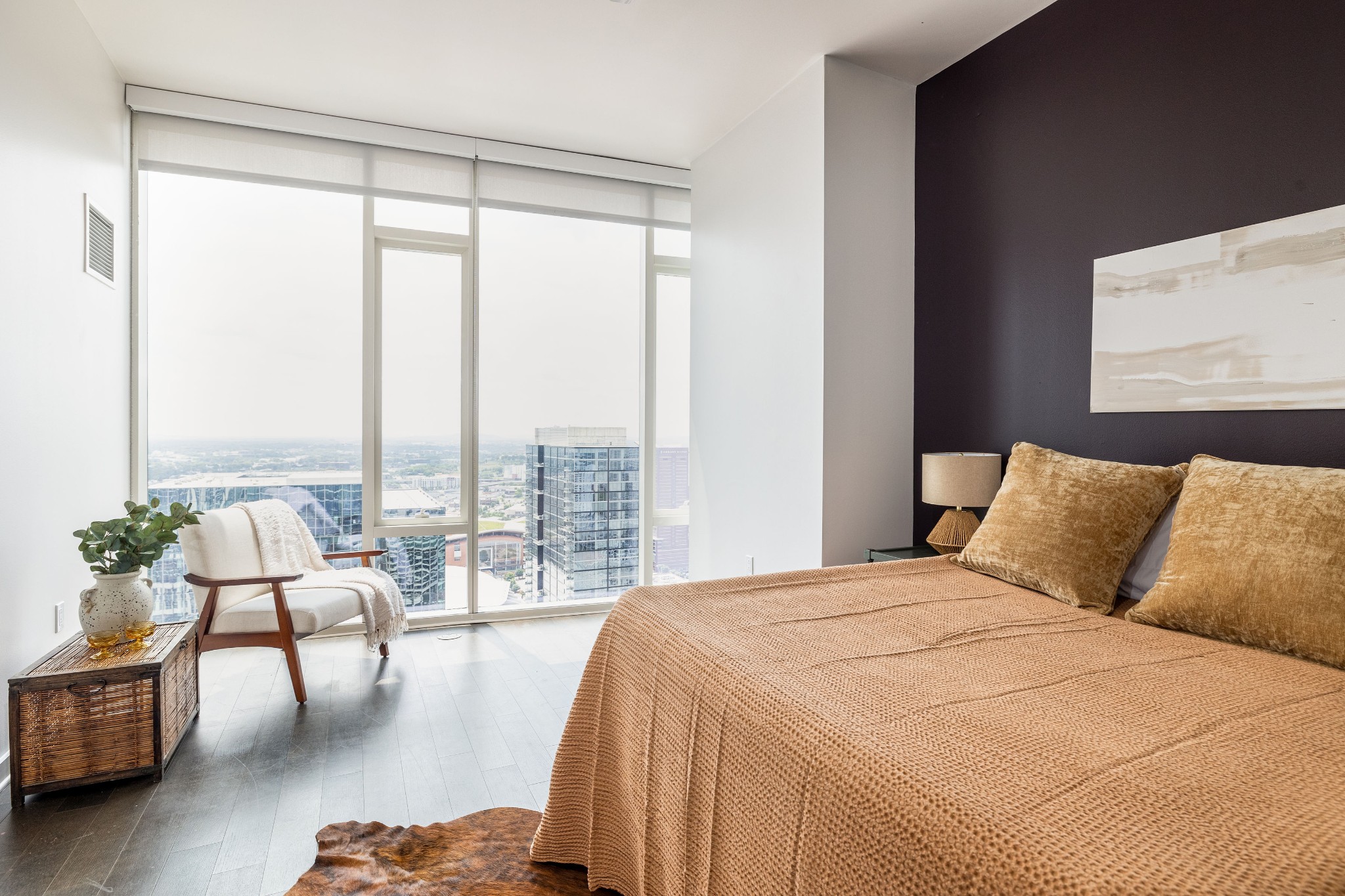 a bedroom with a bed and large windows