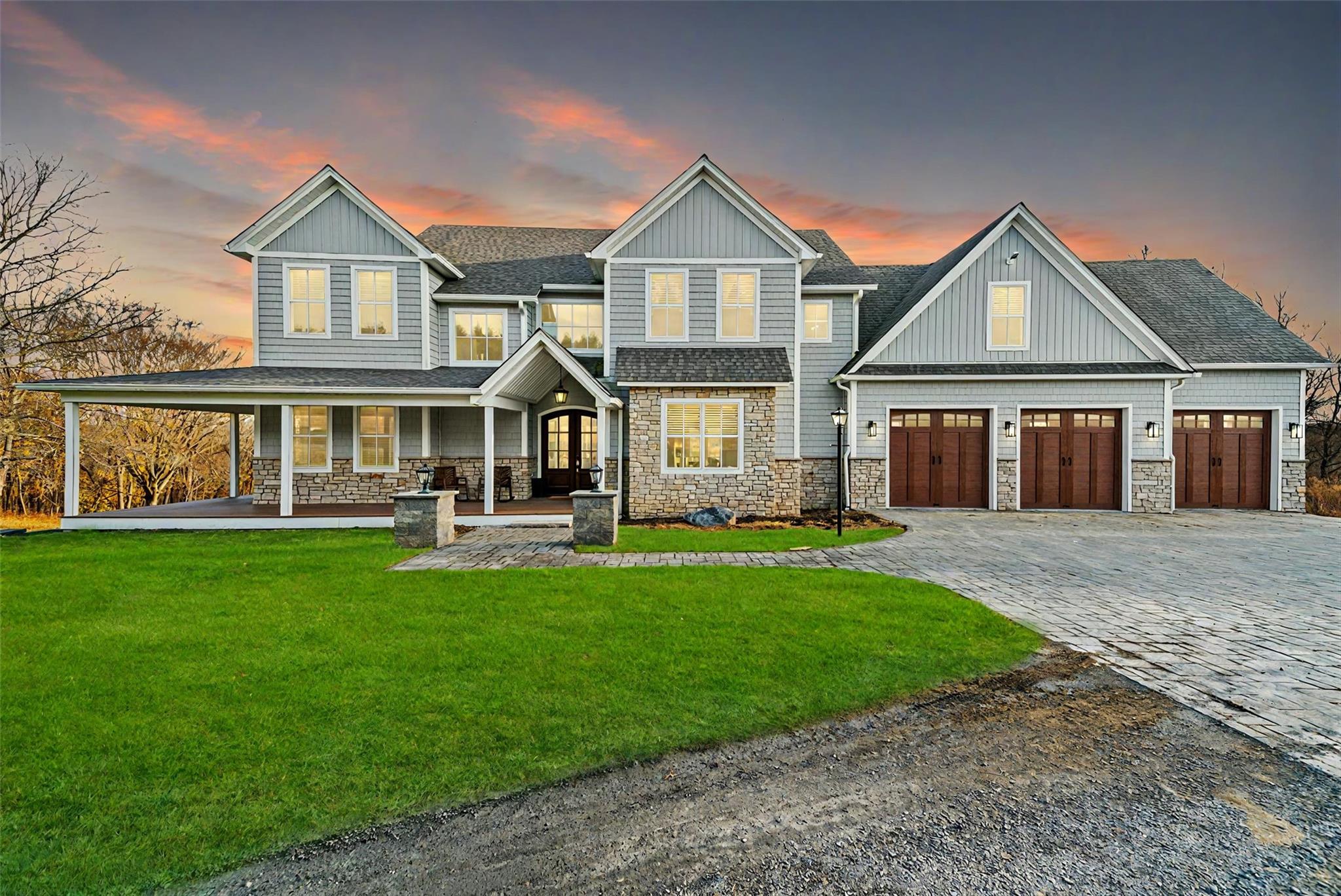 Craftsman inspired home featuring covered porch and a yard