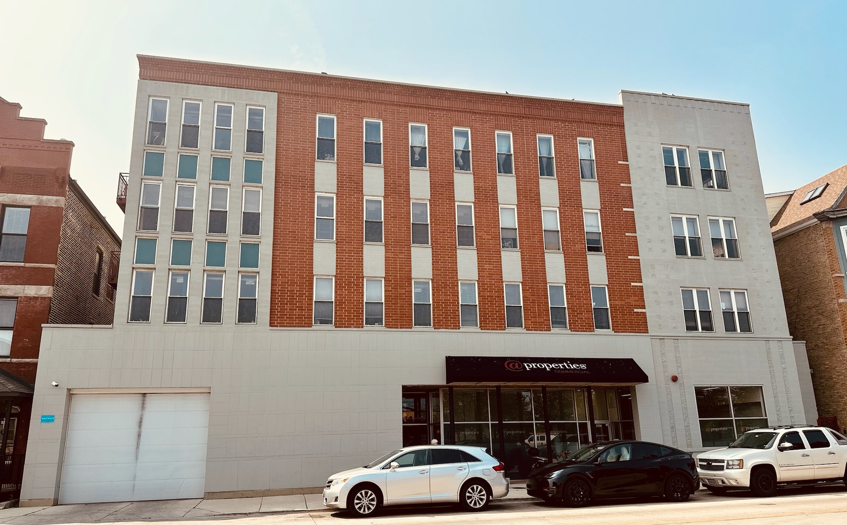 a front view of a building with parking space