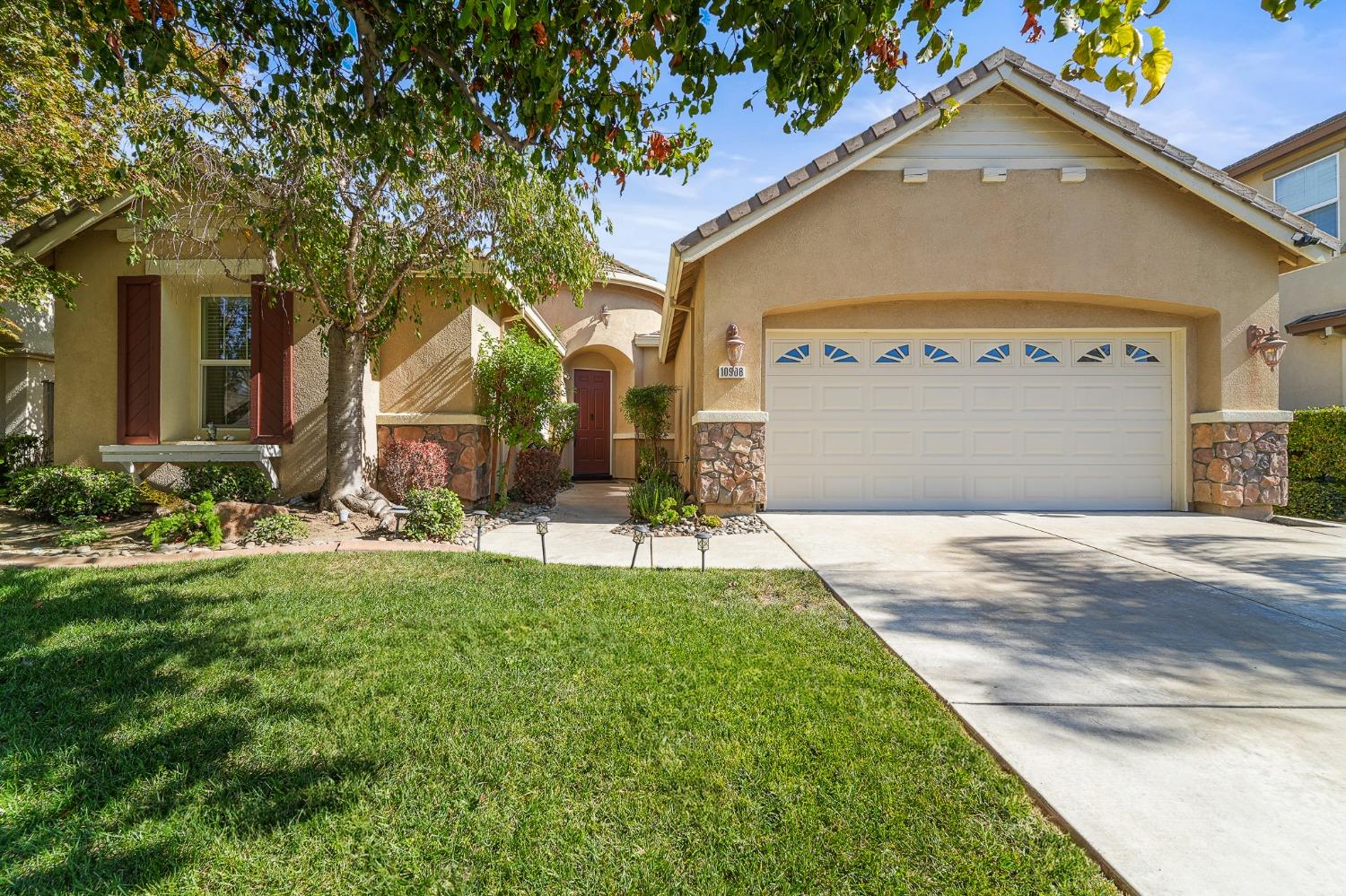 a front view of a house with a yard and garage