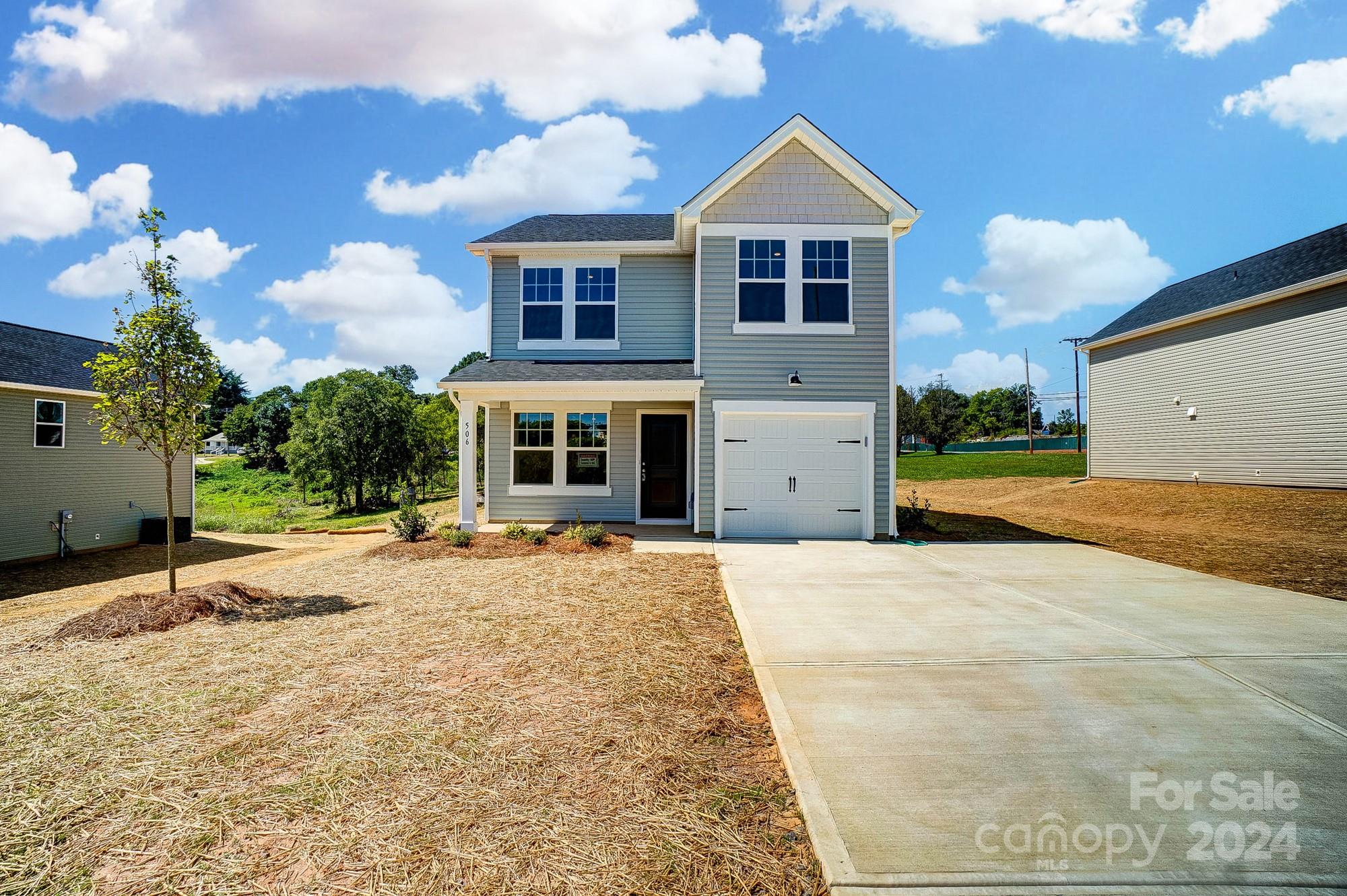 a front view of a house with a yard and garage