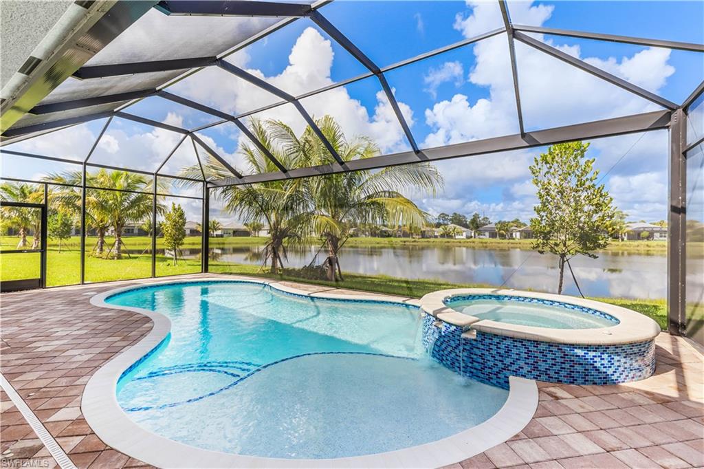 a view of a swimming pool with a yard from a tub