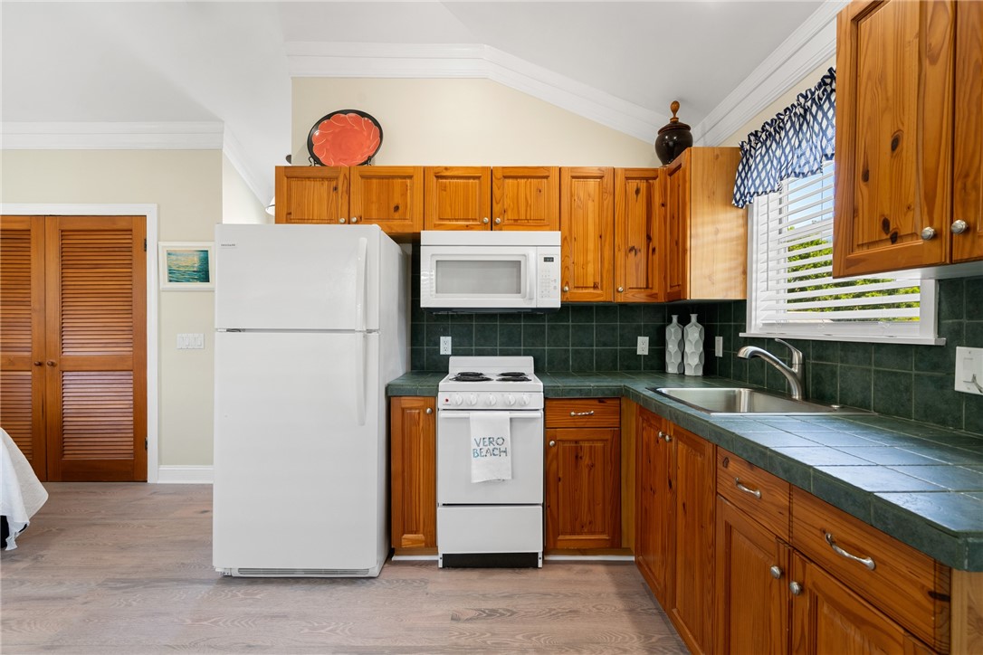 a kitchen with stainless steel appliances granite countertop a refrigerator a stove and a sink