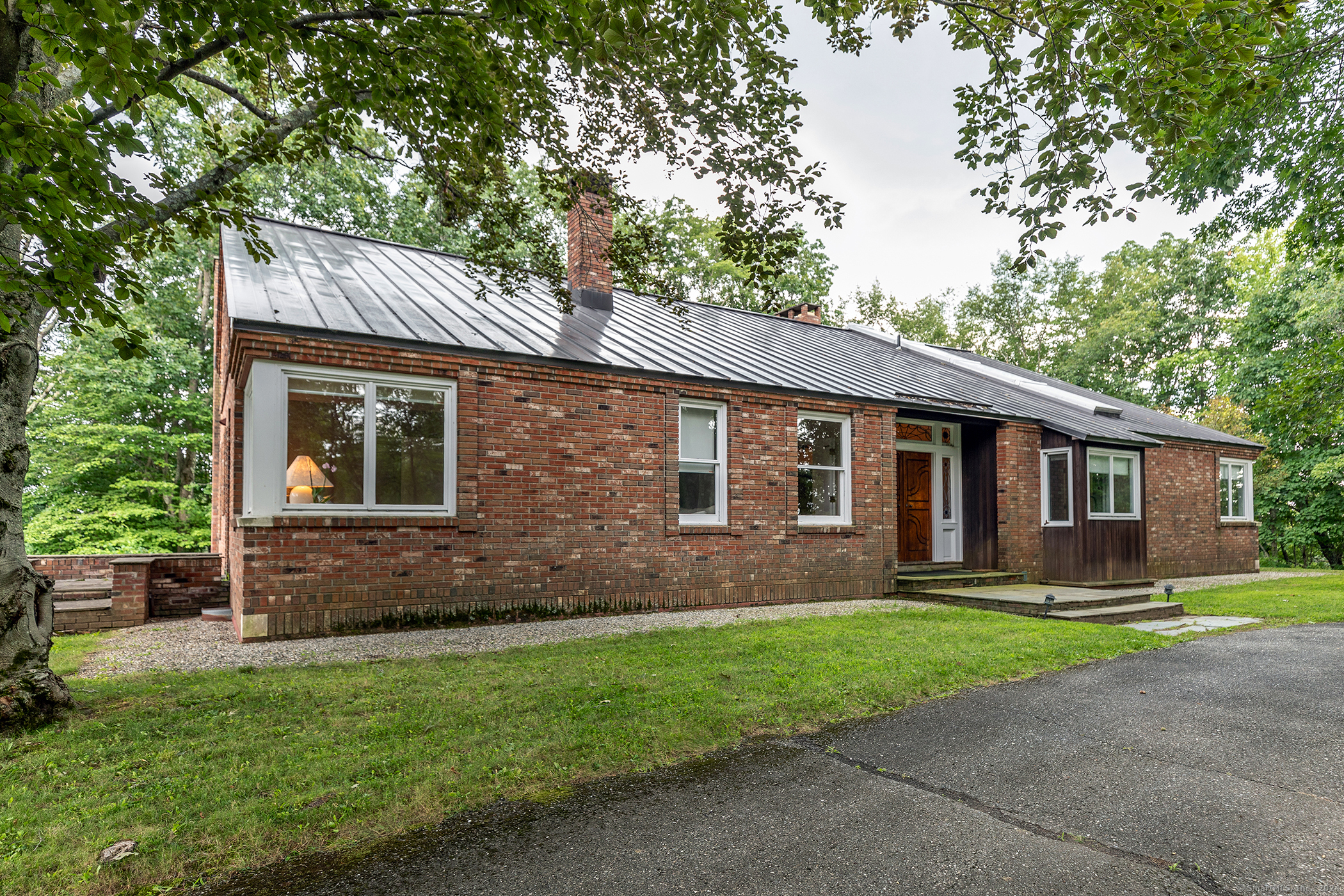 a front view of house with yard and green space