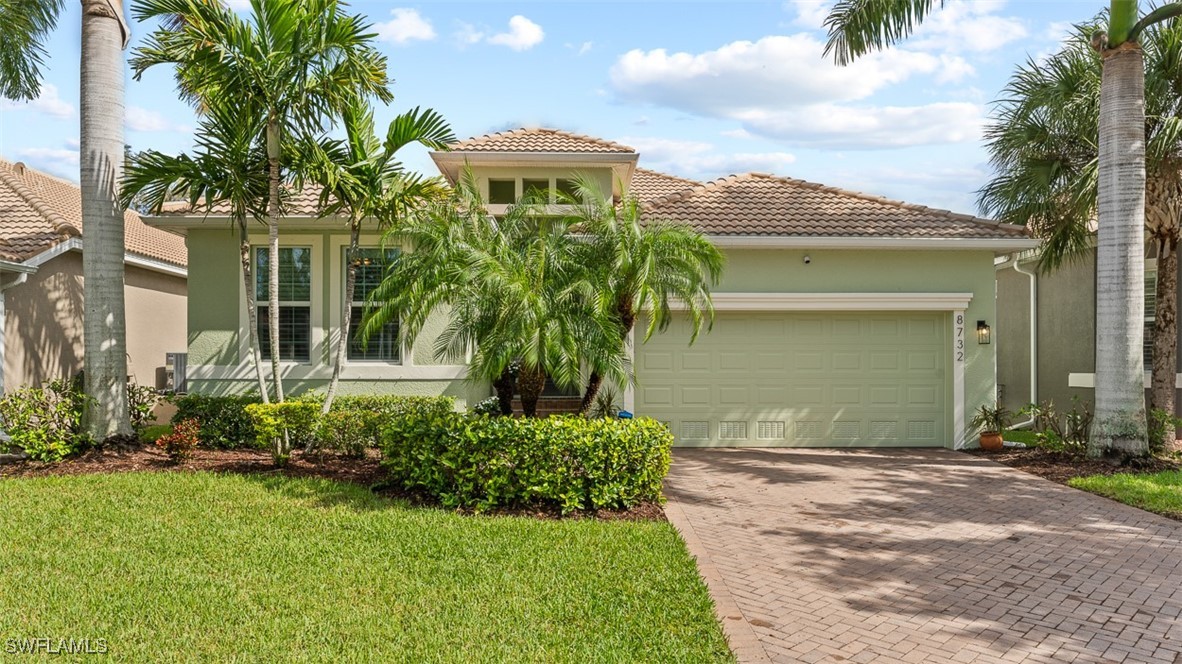 a front view of a house with a yard and garage