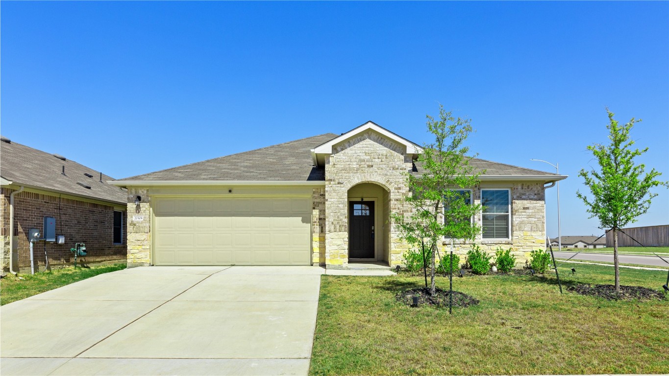 a front view of a house with a yard