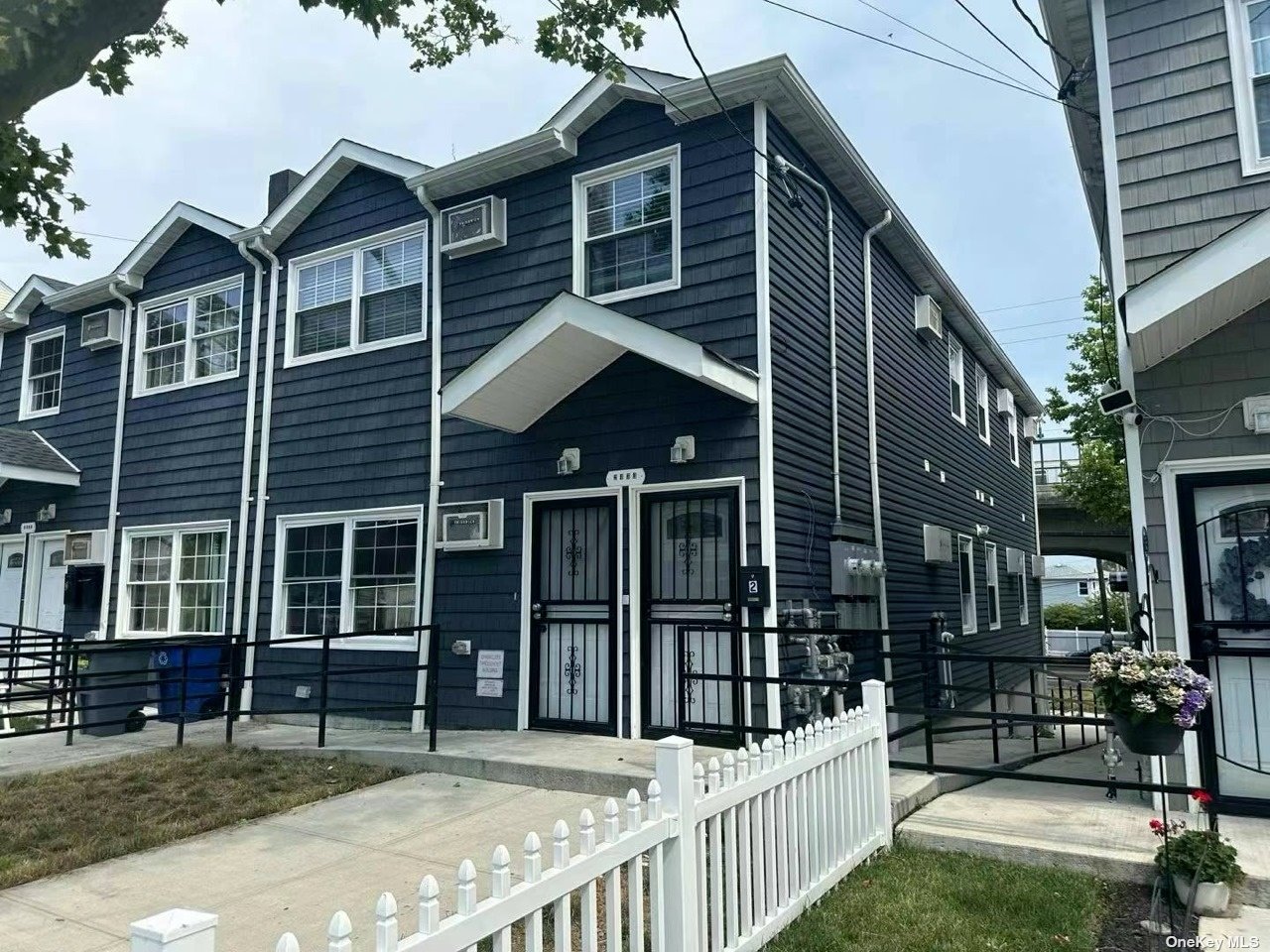 a view of a house with wooden fence