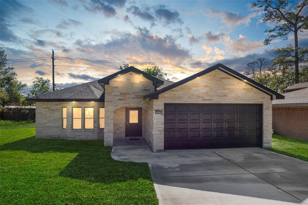 a front view of a house with a yard and garage