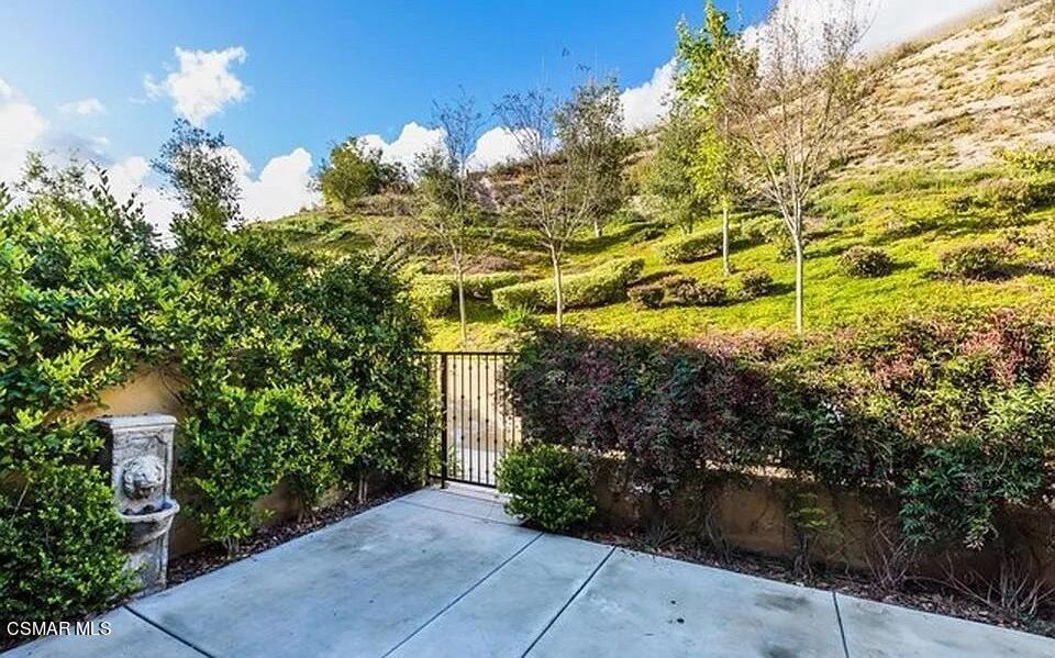 a view of a pathway both side of house