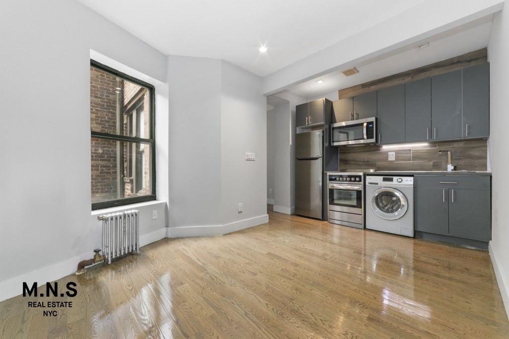 a view of a kitchen with a sink dryer and washer