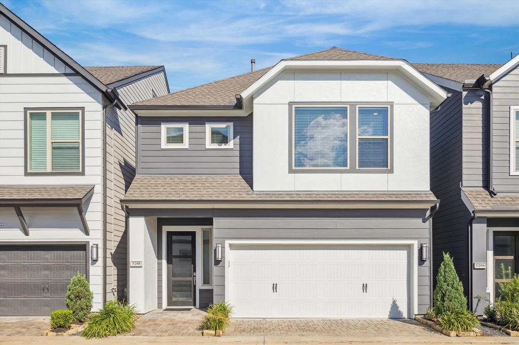 a front view of a house with a garage