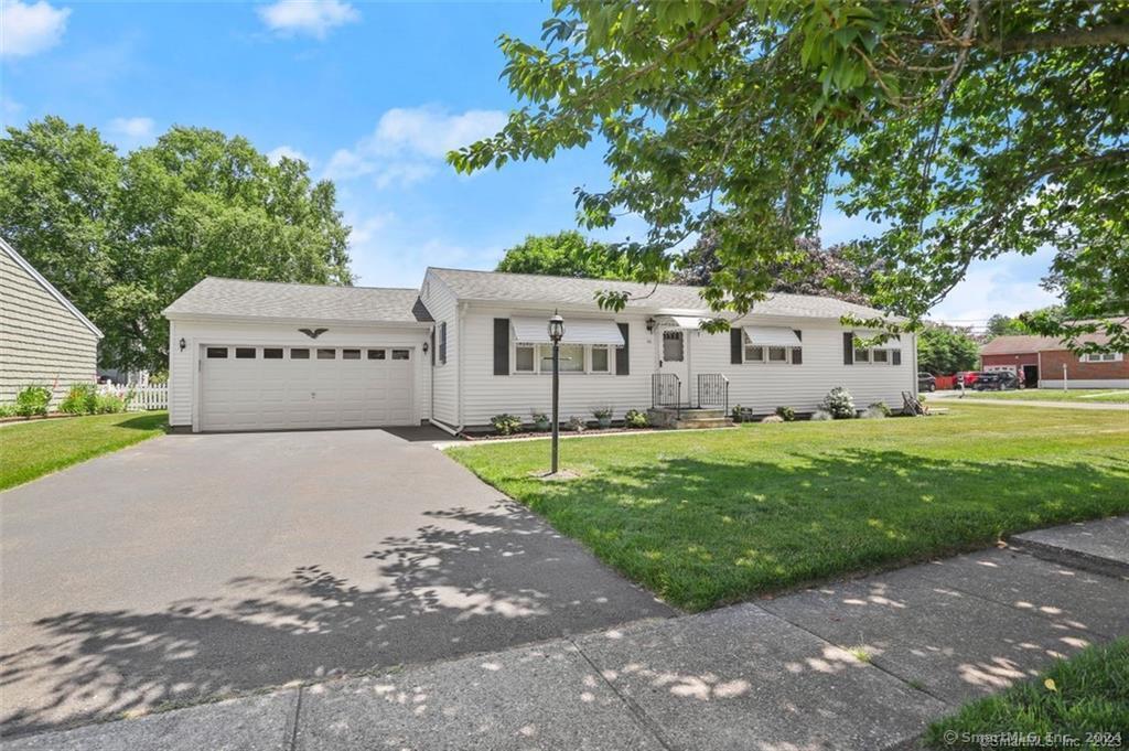 a view of a white house with a yard